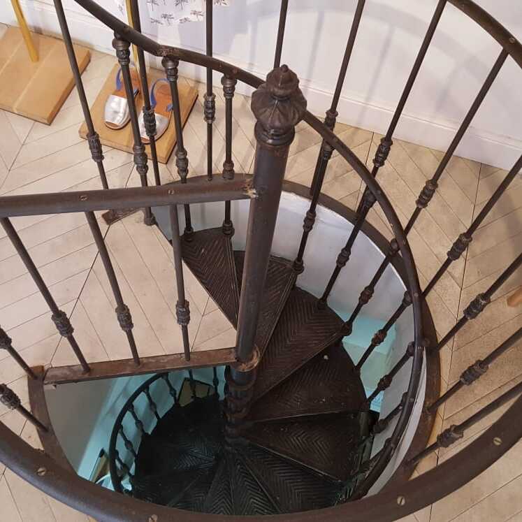 Cast iron spiral staircase Mirecourt model in the clothes shop Marie Sixtine, 75011 Paris (France)
