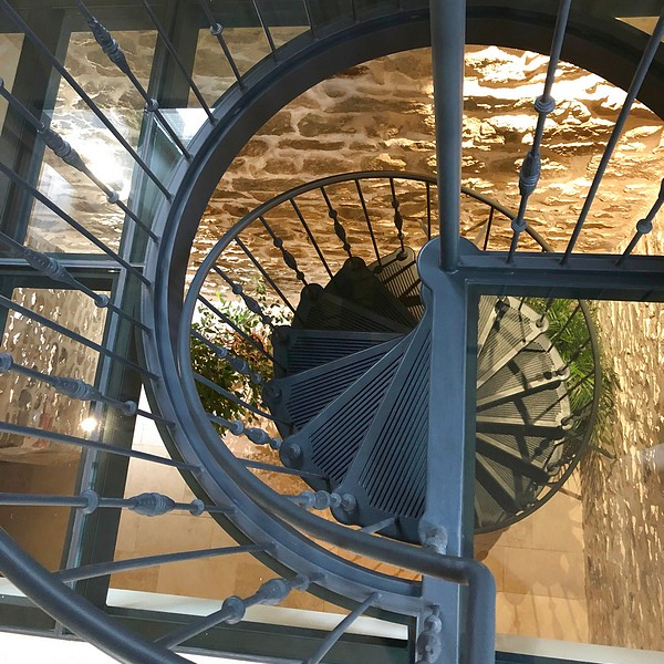 Cast iron spiral staircase model Paris - bespoke glass landing created by the customer